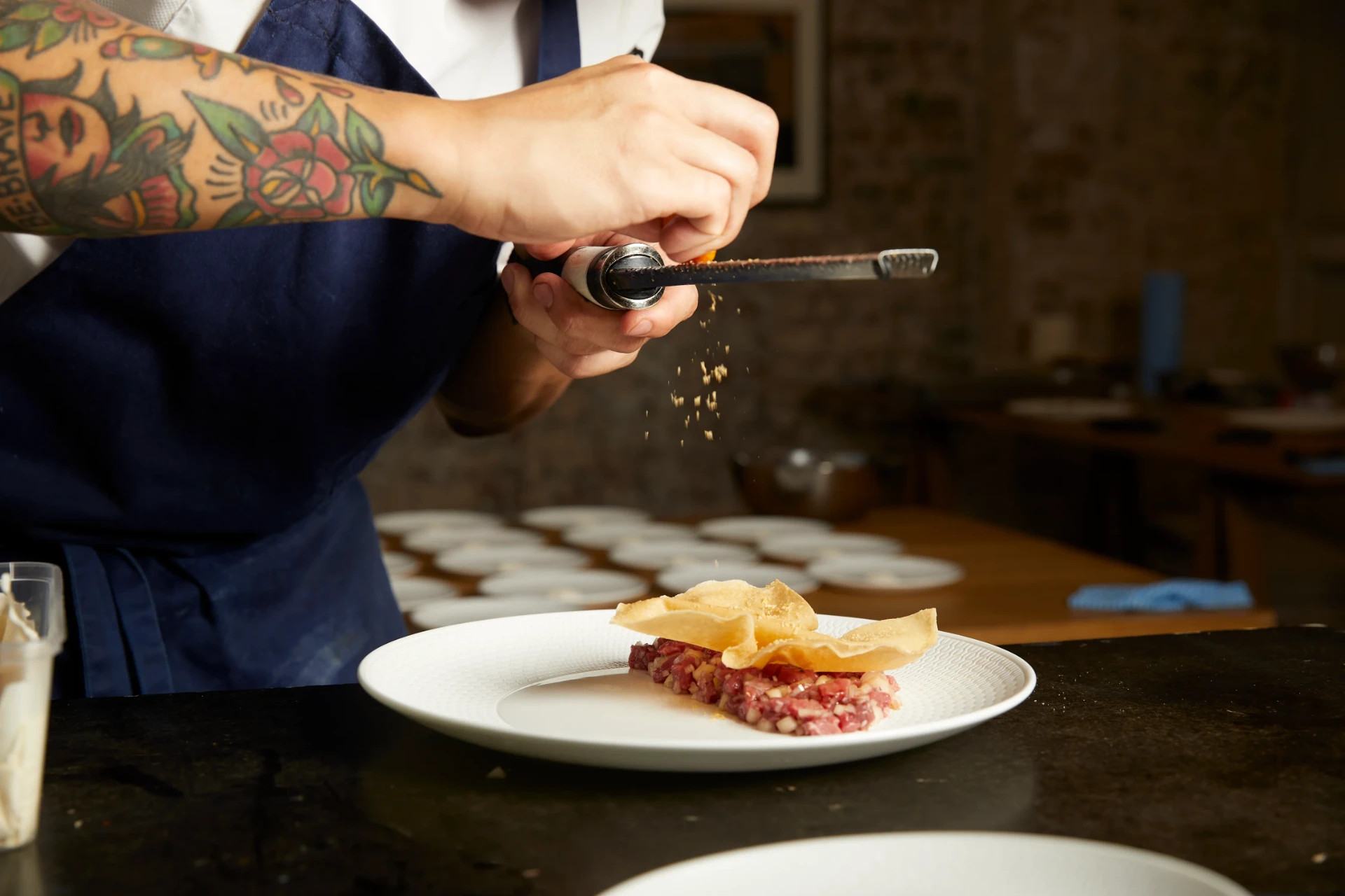 Grating cured egg over beef tartare — Kreative Catering, Sydney event catering