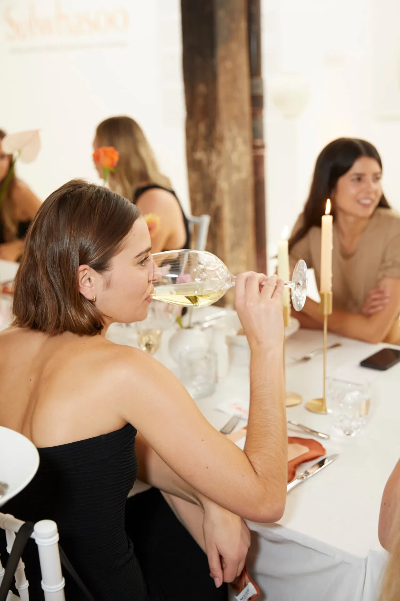 Guests gathered at a modern corporate product launch in a Sydney venue, with a food table in the foreground.